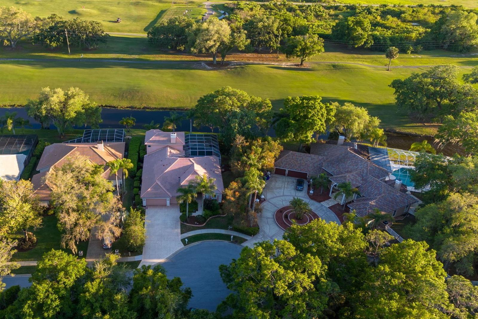 Aerial view of the front of the home with private cul-de-sac and pond between the homes and North golf course