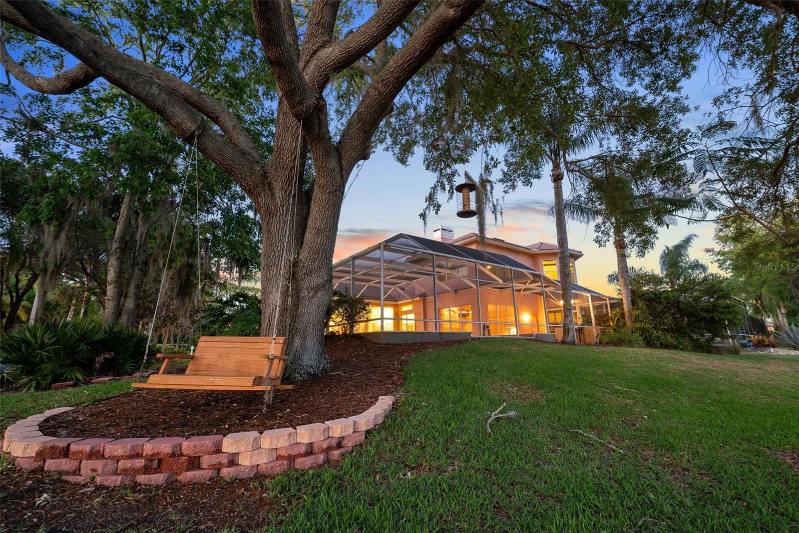 View of the swing and back of the home at sunset