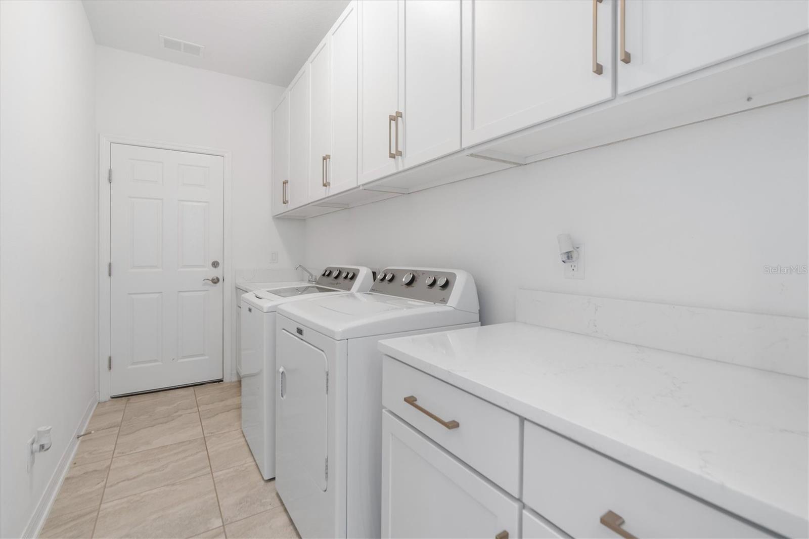 LAUNDRY WITH MANY CABINETS FOR STORAGE
