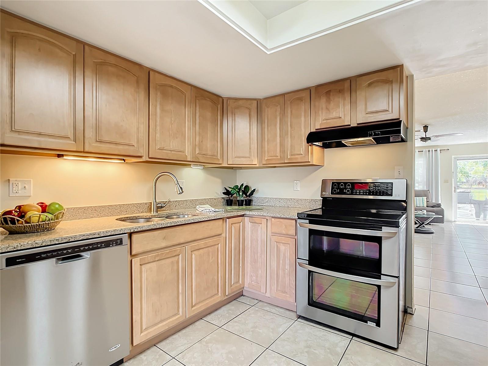 Large, remodeled kitchen with quality wood cabinets and granite counters, under cabinet lighting