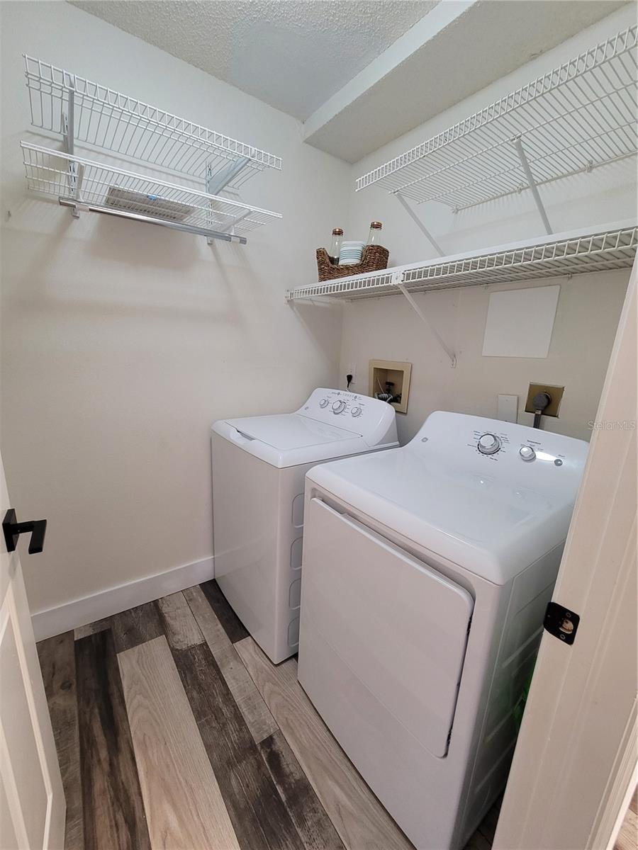 Laundry room with shelving on left wall also that you can't see