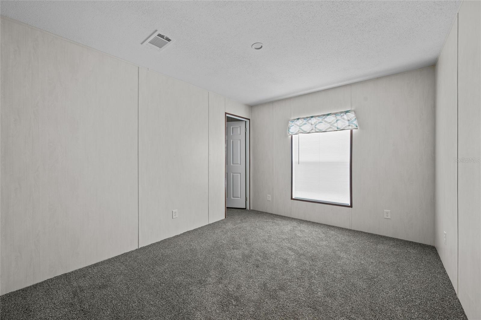 3rd bedroom with walk in closet- Stock photo from builder - Under construction