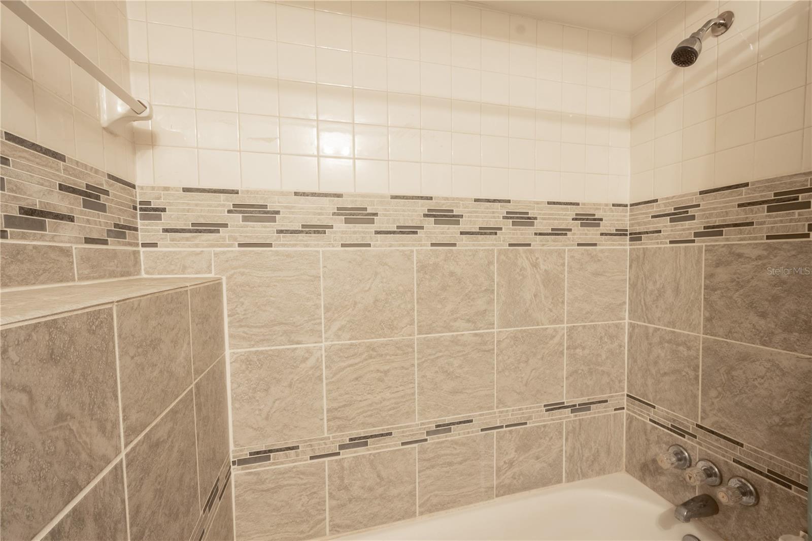 The tub features decorative tile.
