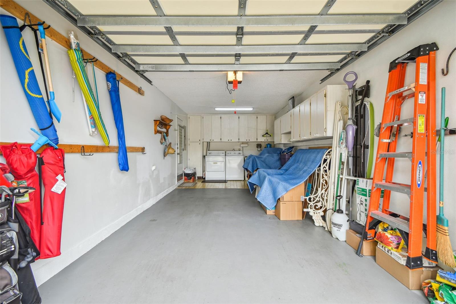long garage w/ lots of cabinet and hanging space