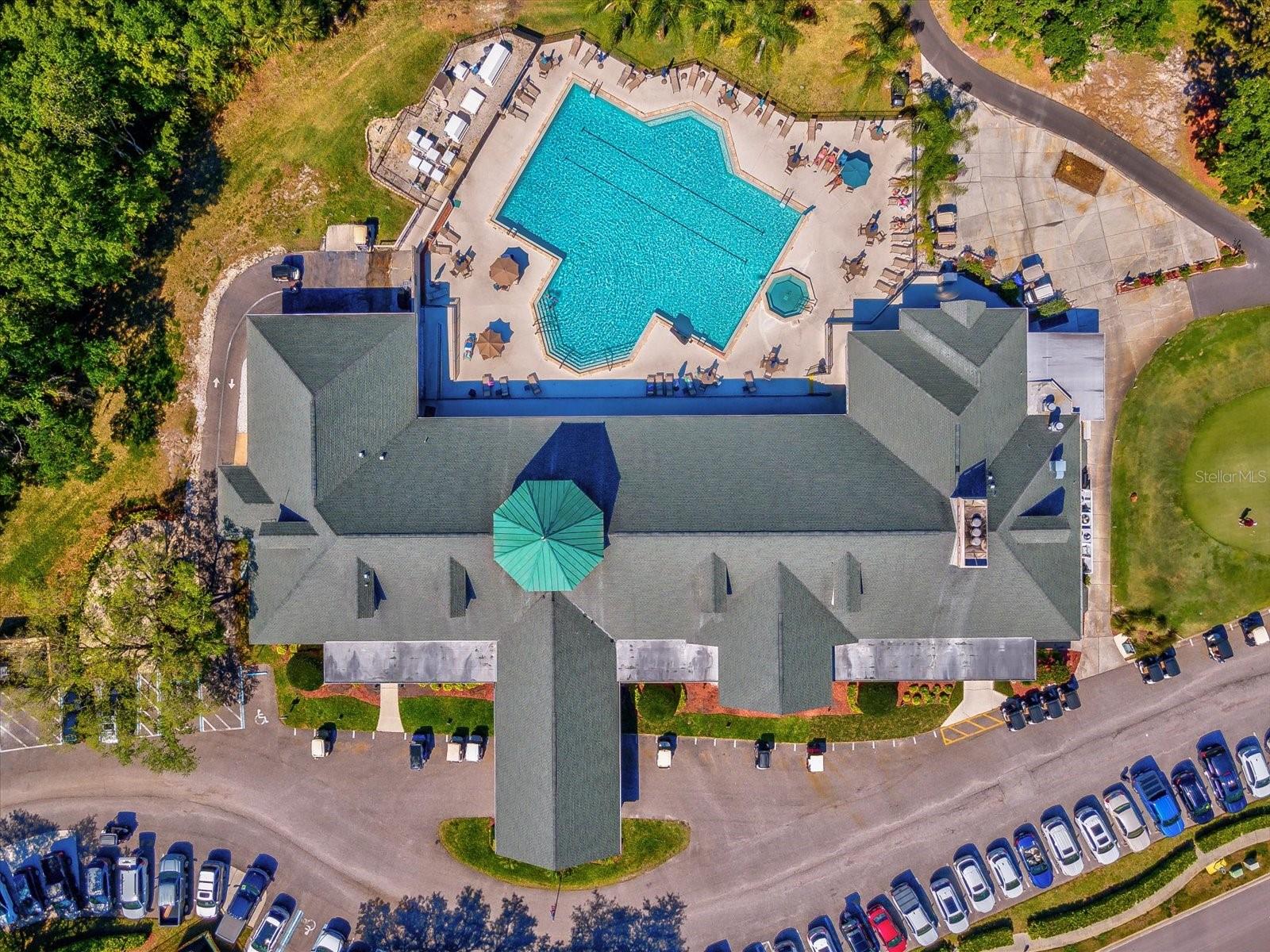 Drone views of clubhouse and heated pool and spa