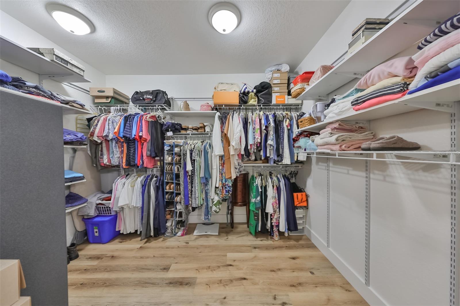 As you walk into this oversized well lit ensuite walk-in closet notice the storage and beautiful flooring.