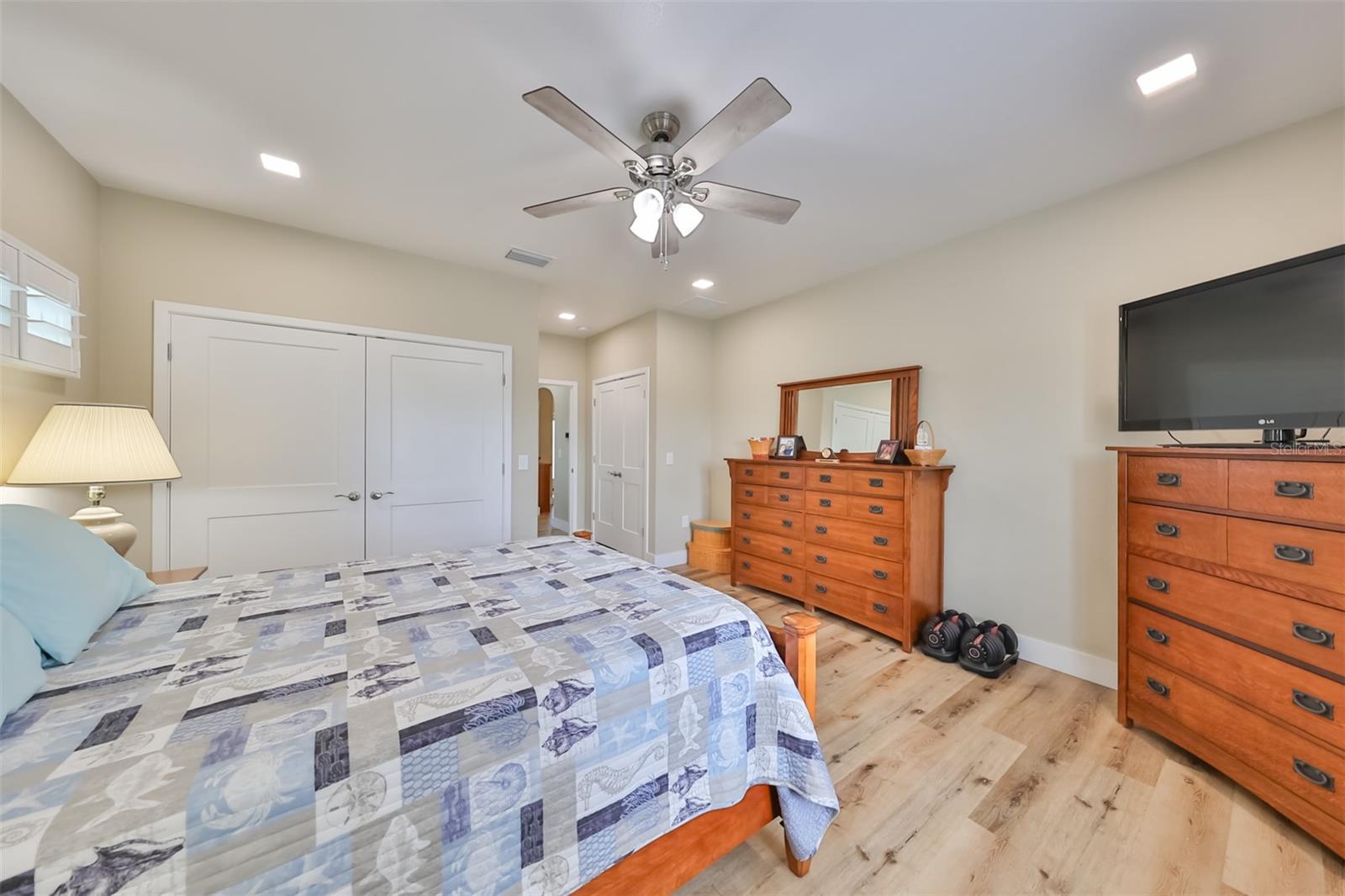 Bedroom 2 includes TWO double French door closets for extra storage space and has a ceiling fan with additional lighting.