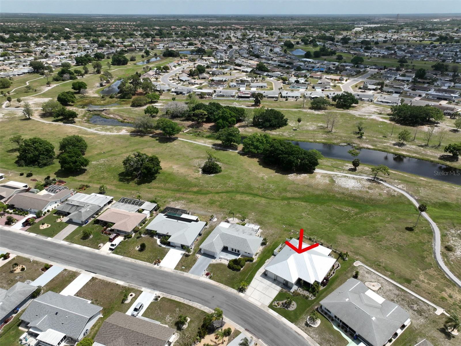 Ariel view of home, outlined with a red arrow.