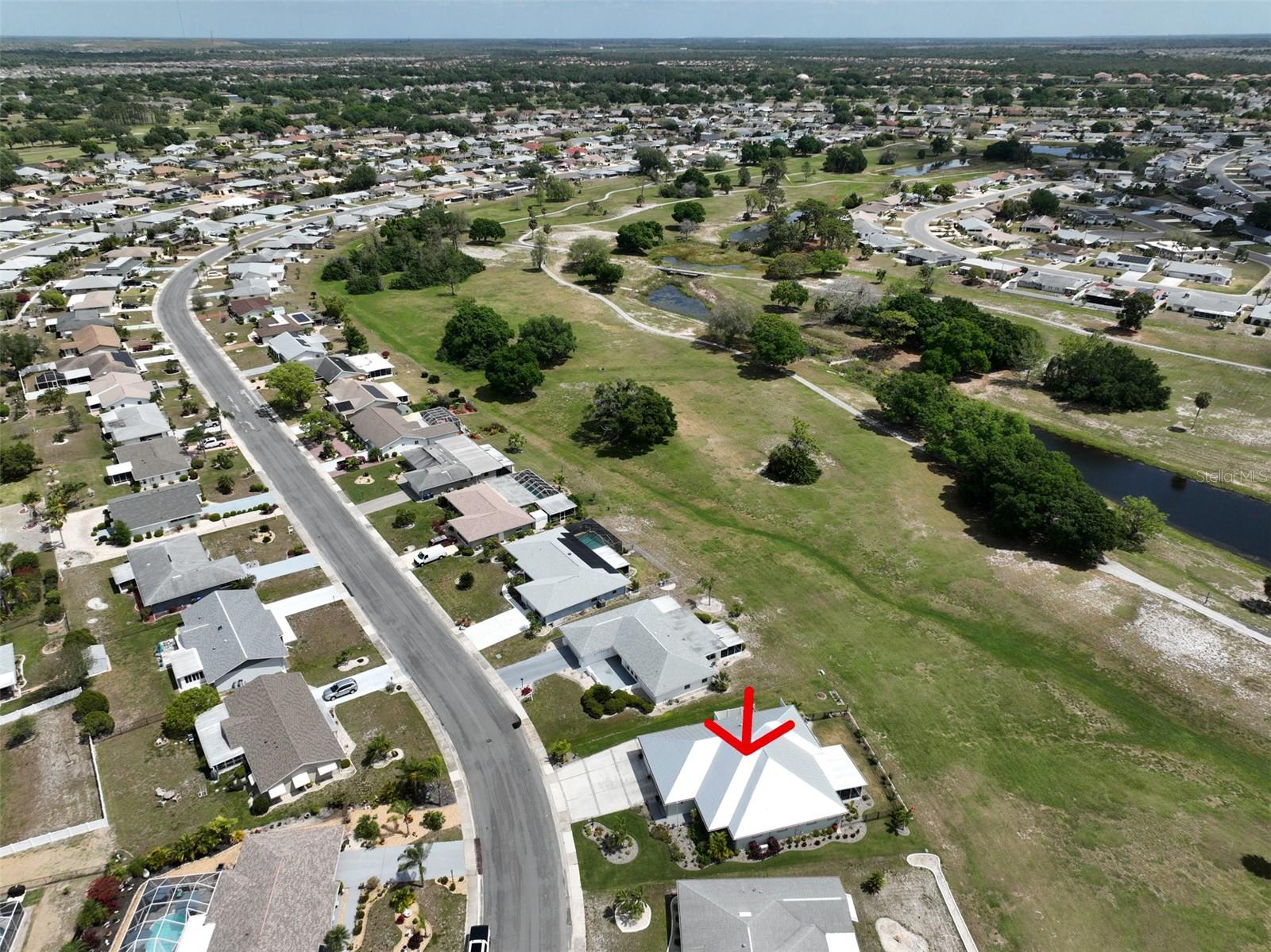 Ariel view of home, outlined with a red arrow.