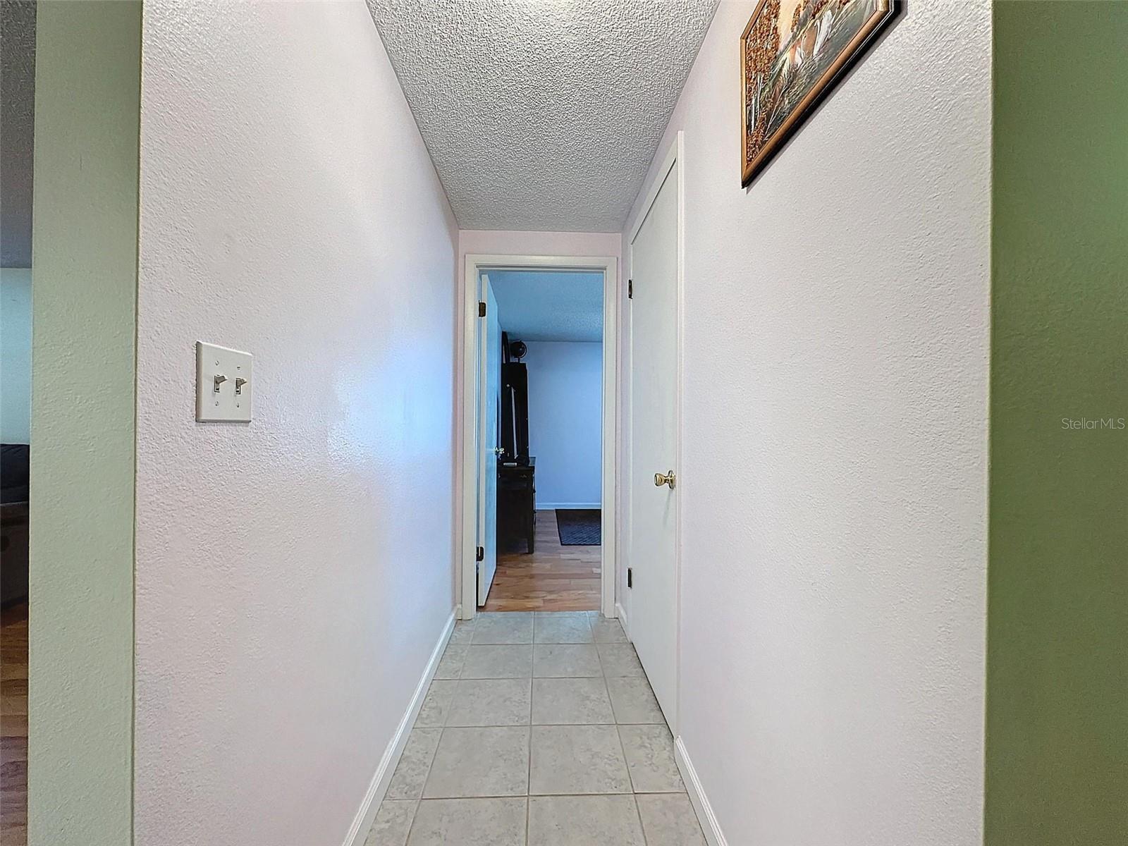 Hallway leads to both bedrooms.