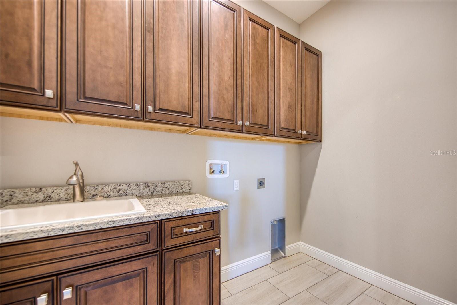 Upstairs Laundry Room with Sink and Granite Counter Top