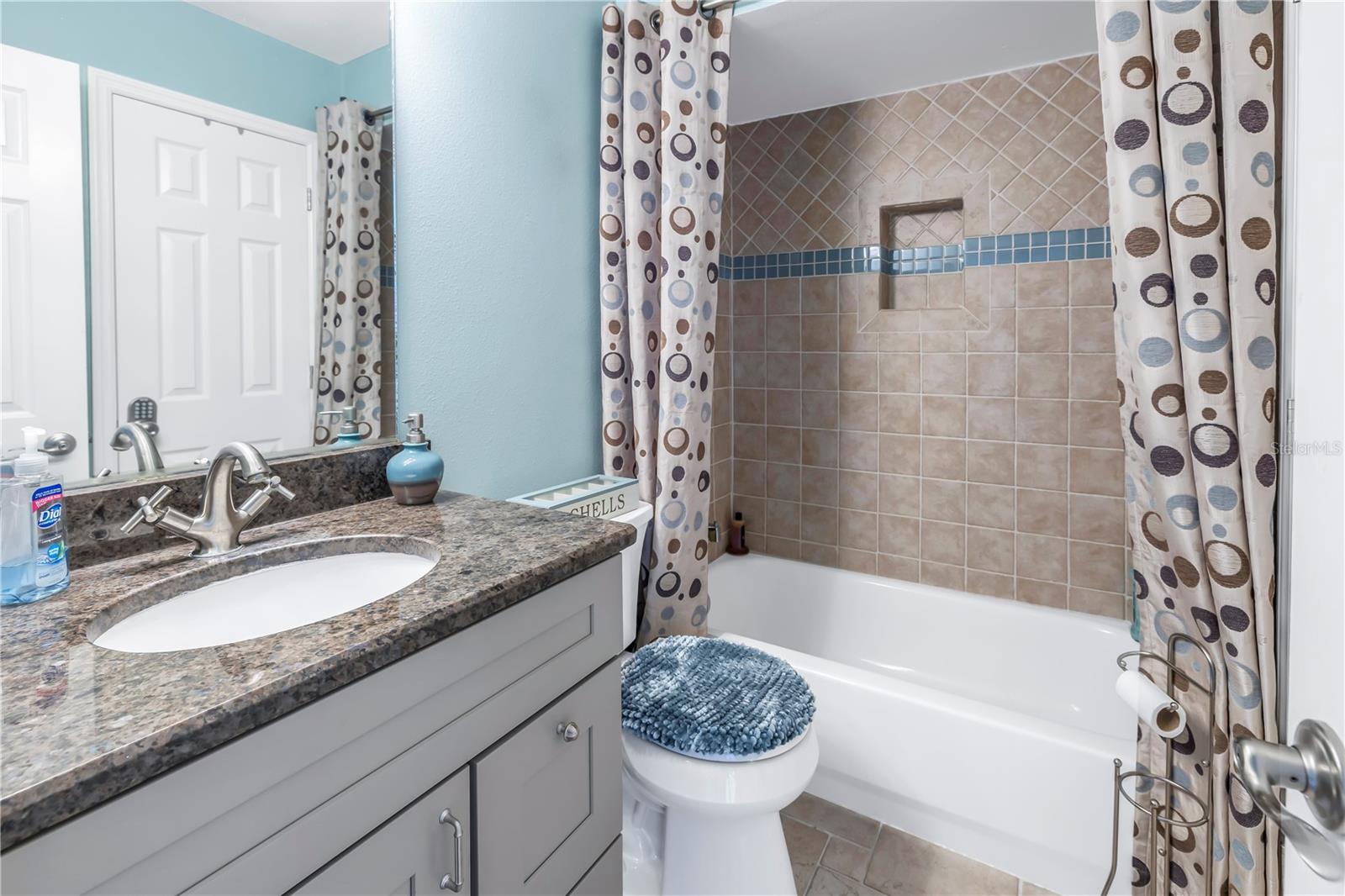 Second bathroom with updated vanity, granite counter and tile