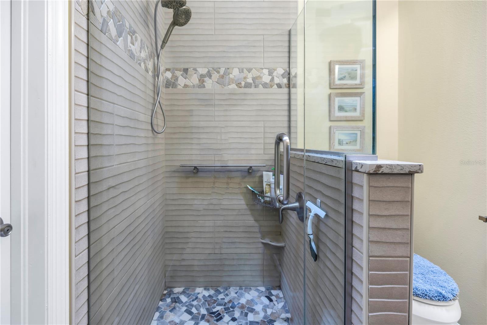 Primary shower updated with neutral tile