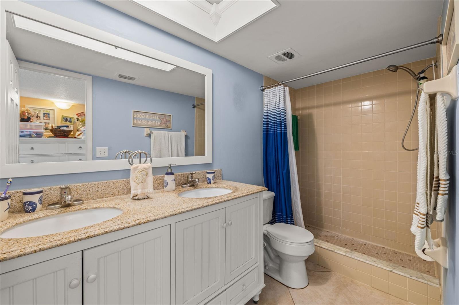Dual sink vanity, walk-in shower, comfort height toilet, updated lighting and vanity mirror.