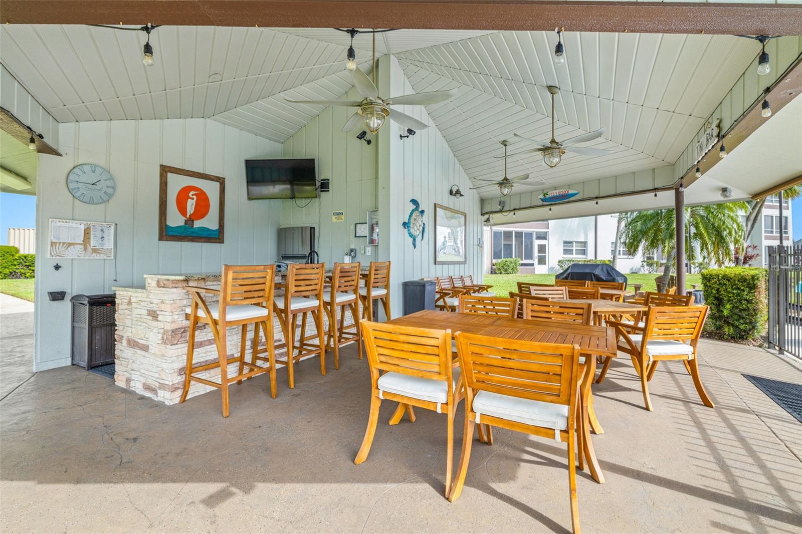 Tiki Hut near the pool for outdoor fun includes a kitchen, seating, and TV for those important sporting events!