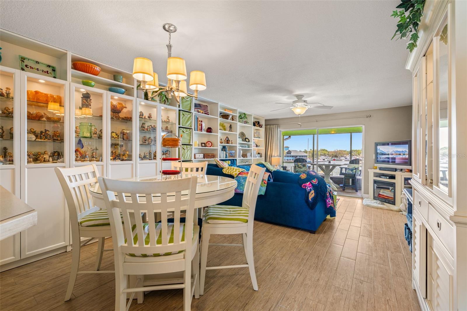 Spacious dining room/living room combo with porcelain wood plank tiles, custom built-in cabinets & shelving with lighting to display all those family photos or collectibles...all with an OCEAN view!