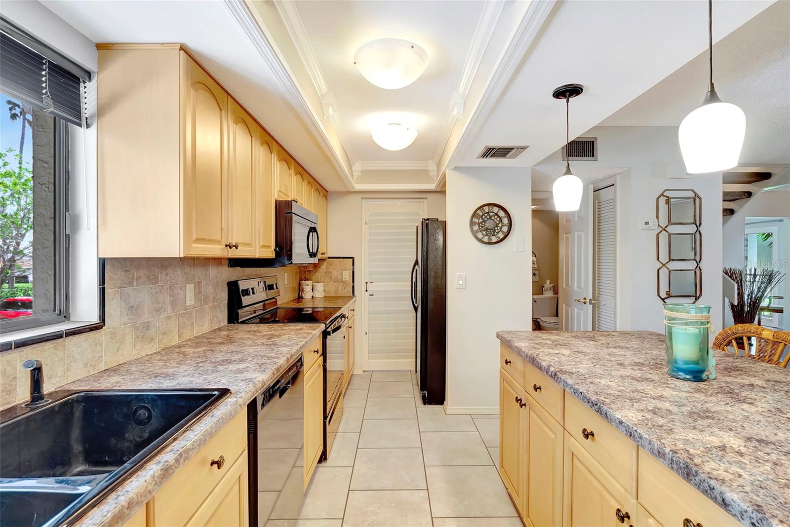 The Laundry room is right off the kitchen behind closed doors and the 1.2 bath is to the right for convenience.