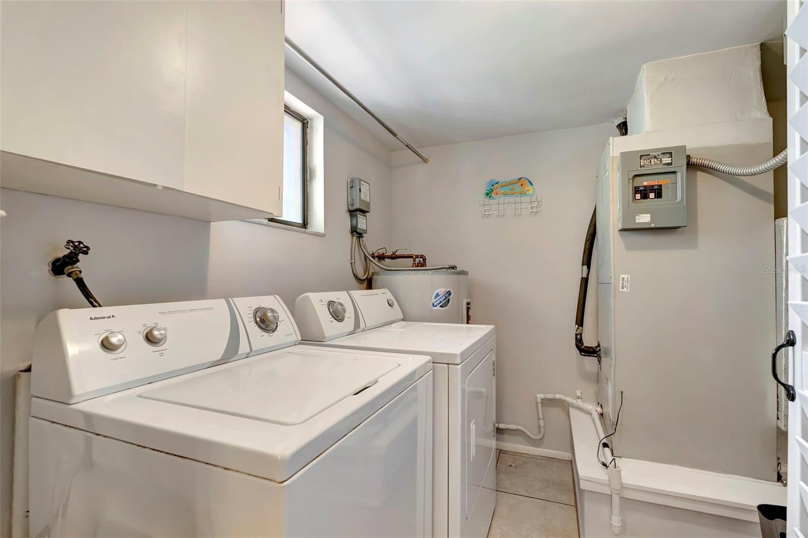 The laundry has built in cabinets and houses your AC and water heater.