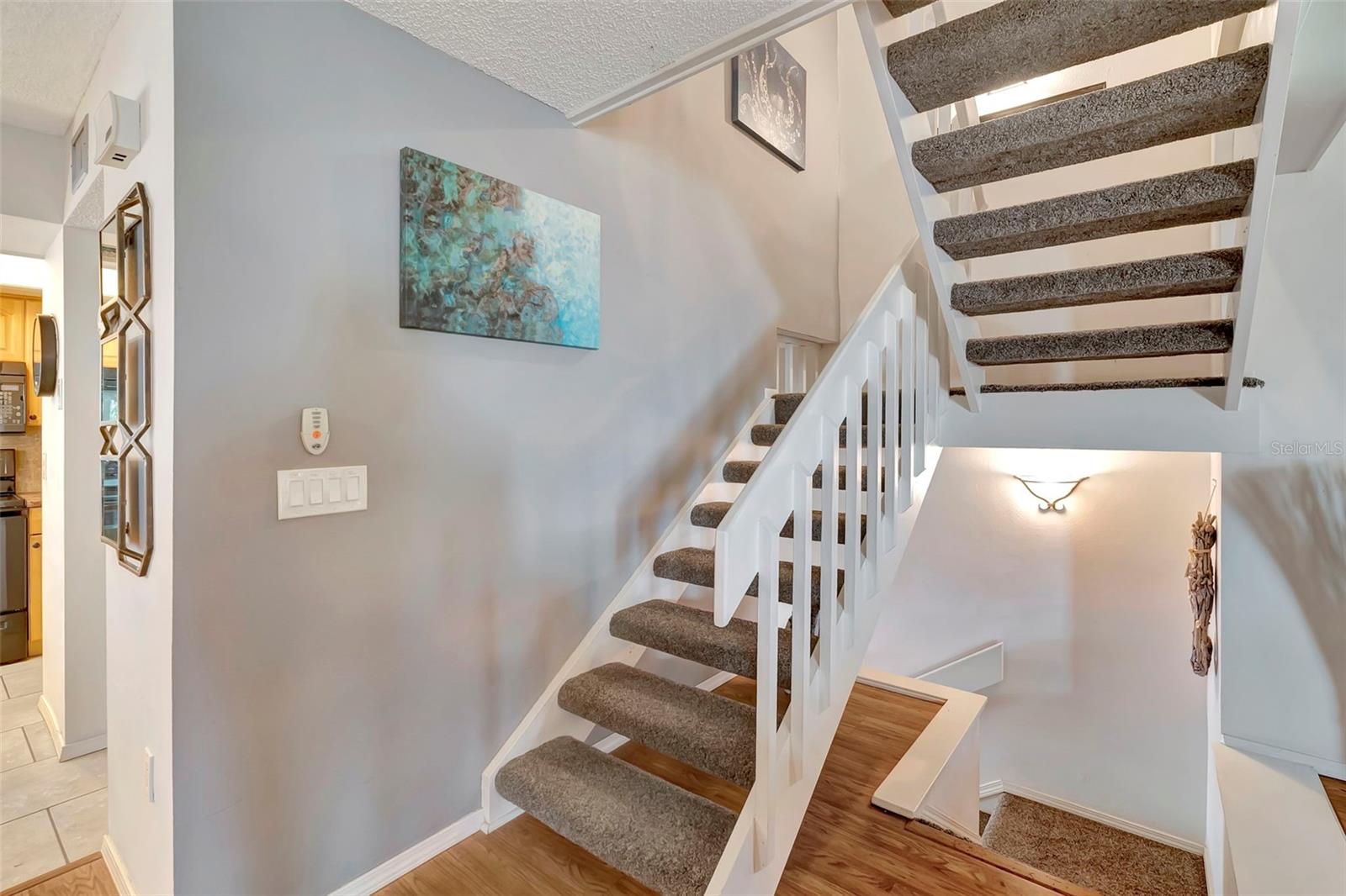 The stairs from the first floor living space lead to the bedrooms.