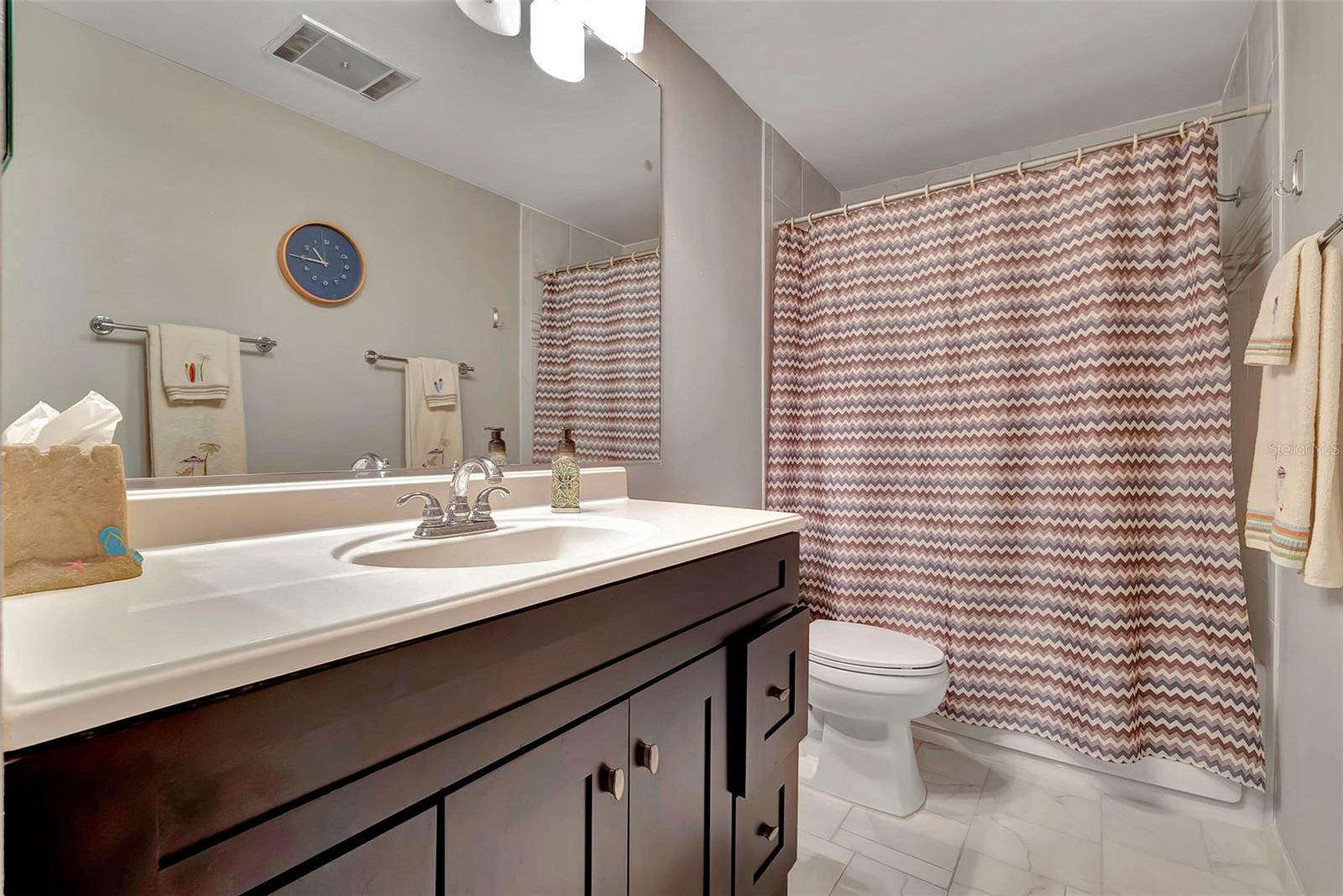 The 2nd-guest bathroom has a tub shower combination