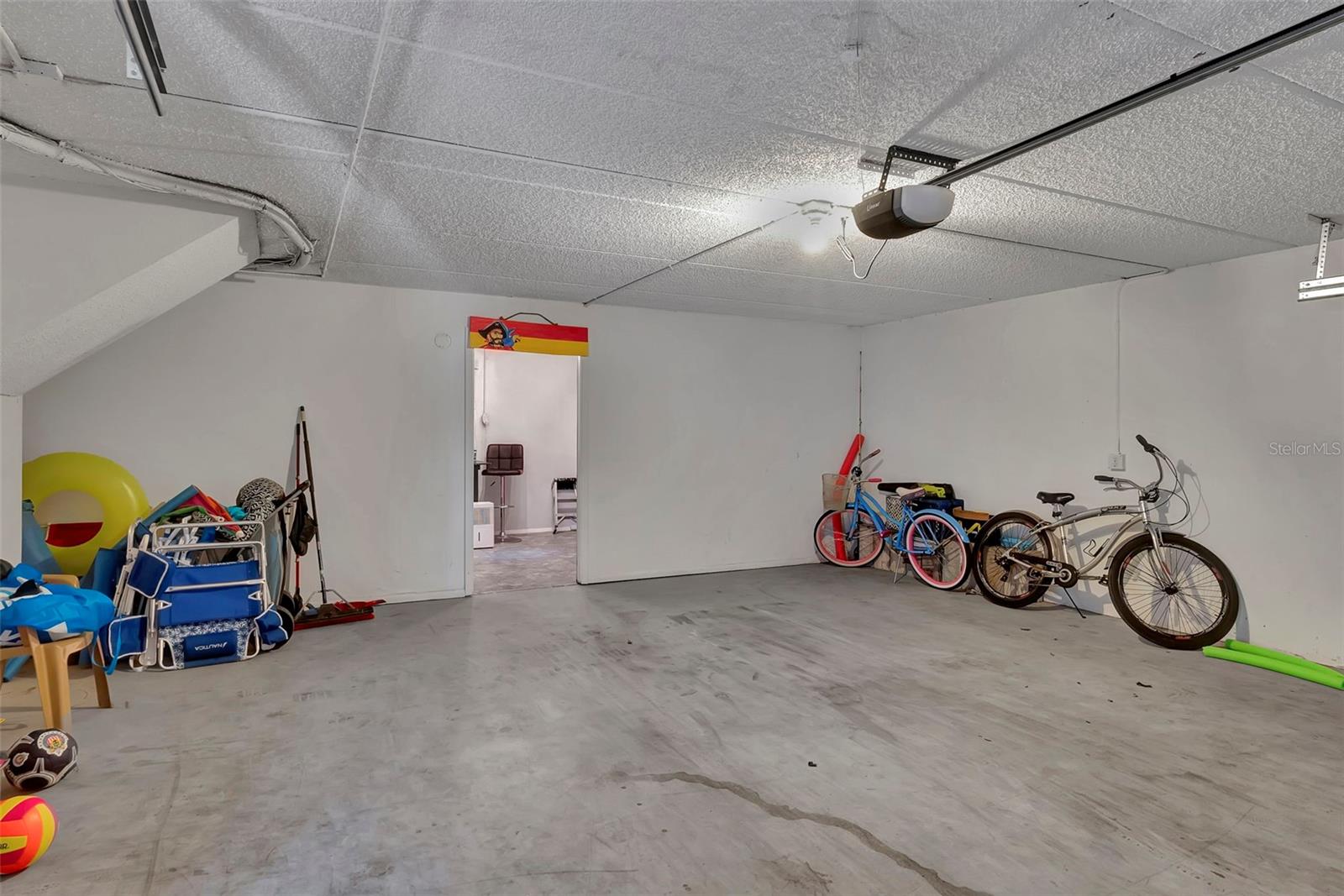 The garage is spacious and has an extra storage.work area in the rear.