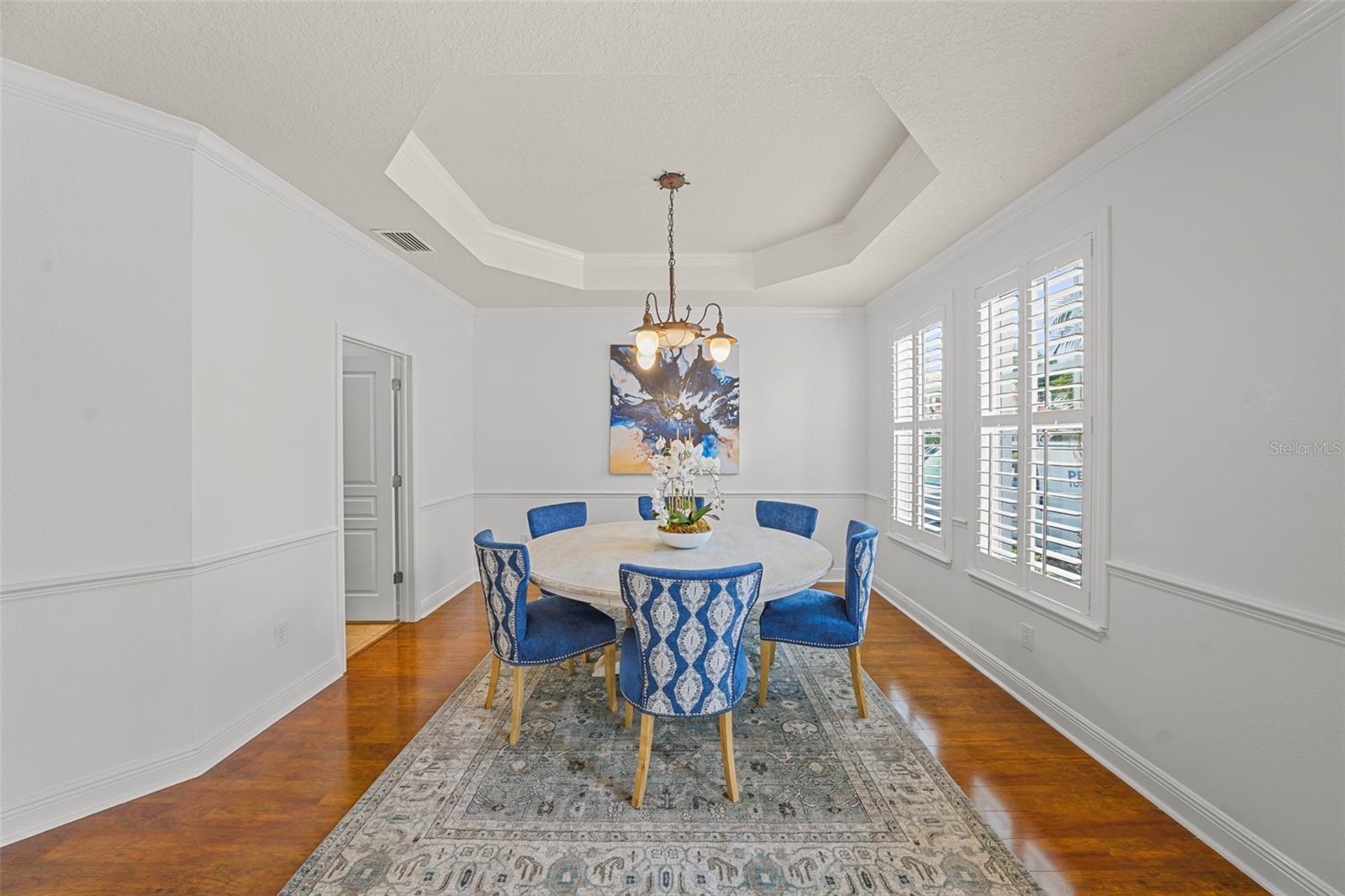Spacious entry foyer, plantation shutters, coffered dining room ceiling, and french doors to study welcome you to your piece of paradise!