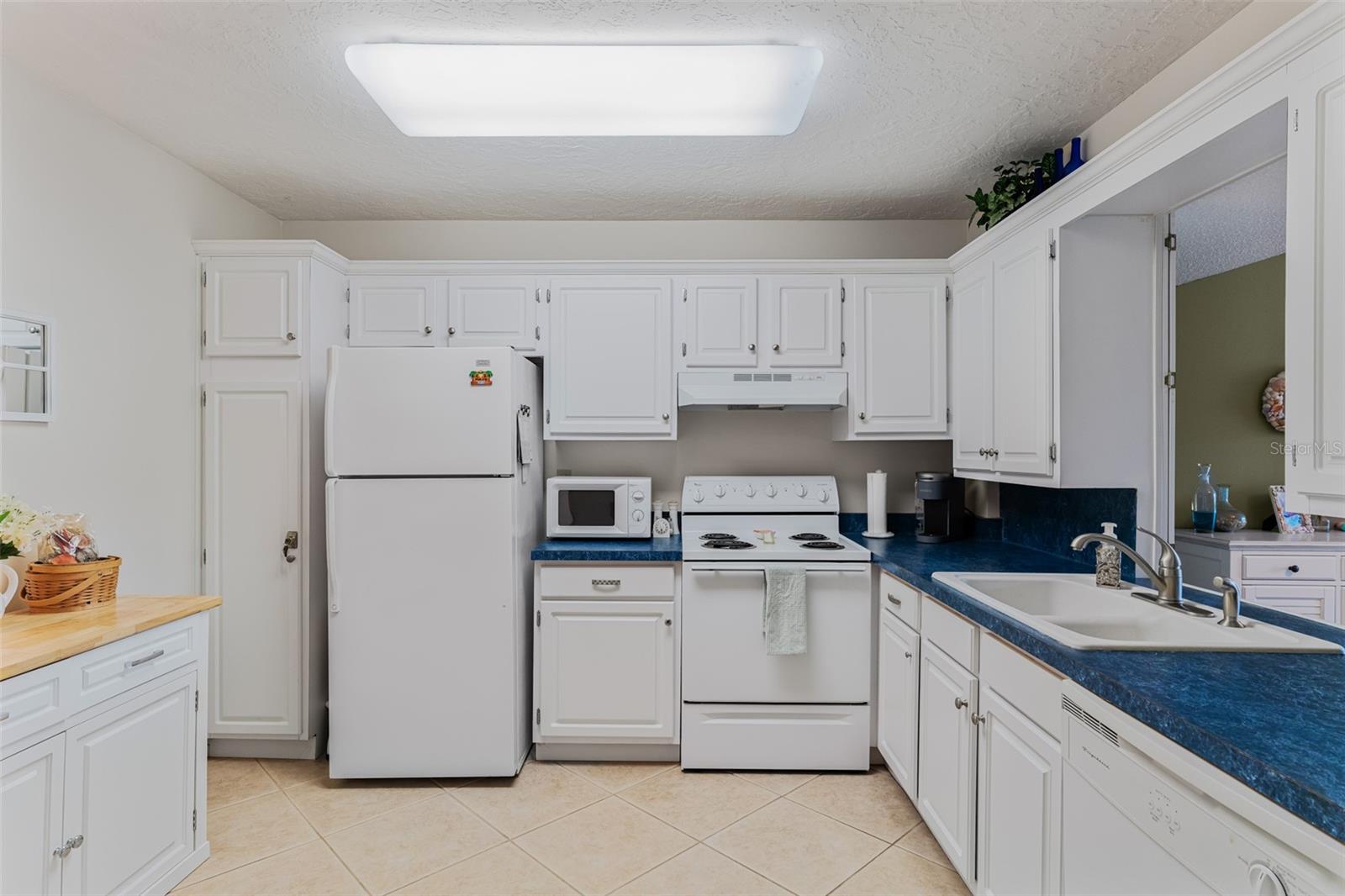 Very clean and bright kitchen with lots of cabinet and counter space