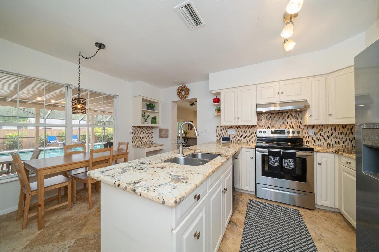 The kitchen overlooks the pool and enters to the family room!