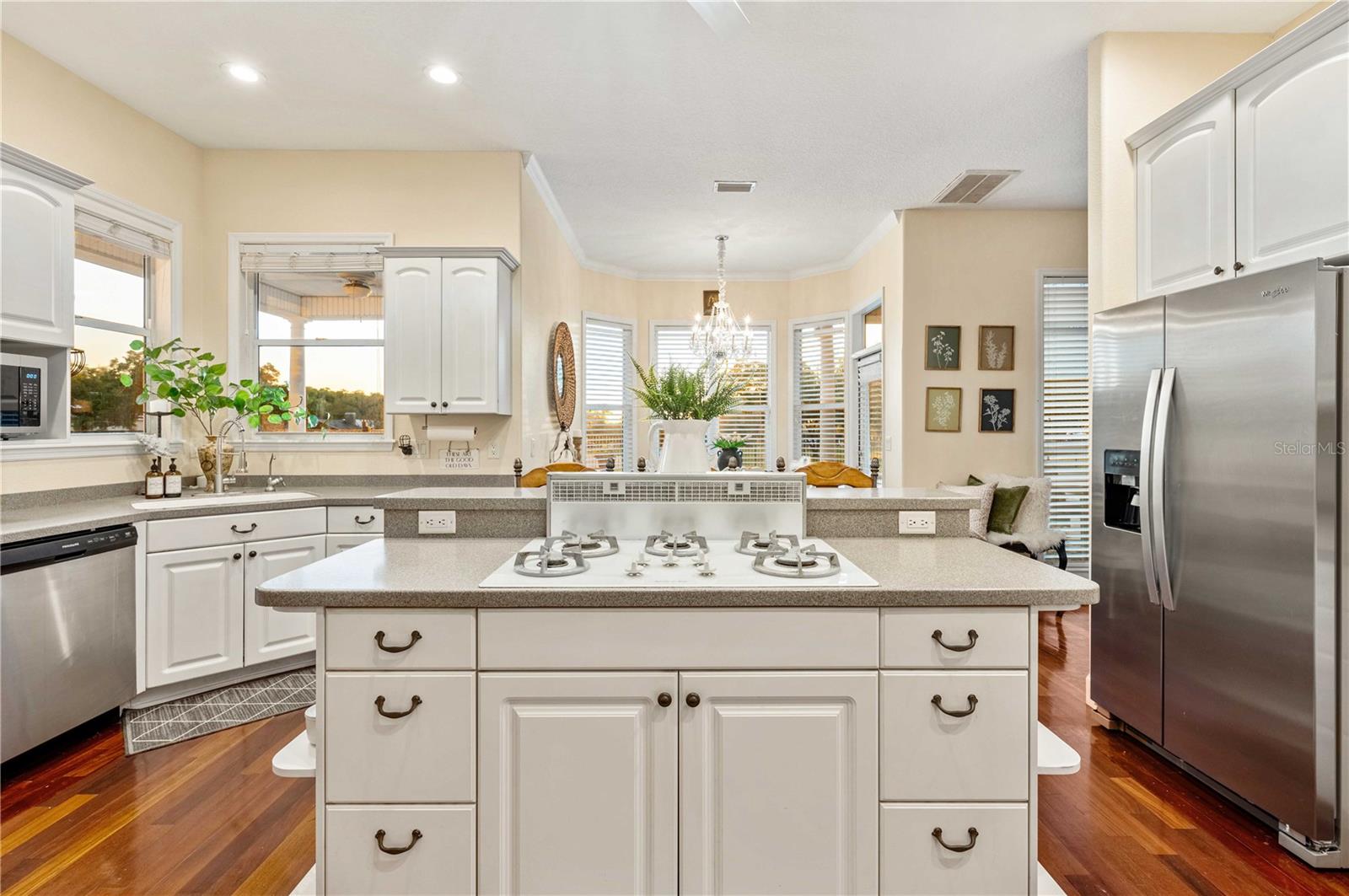 Kitchen with Corian Counters, Custom Cabinets, Gas Cooktop and Double Oven