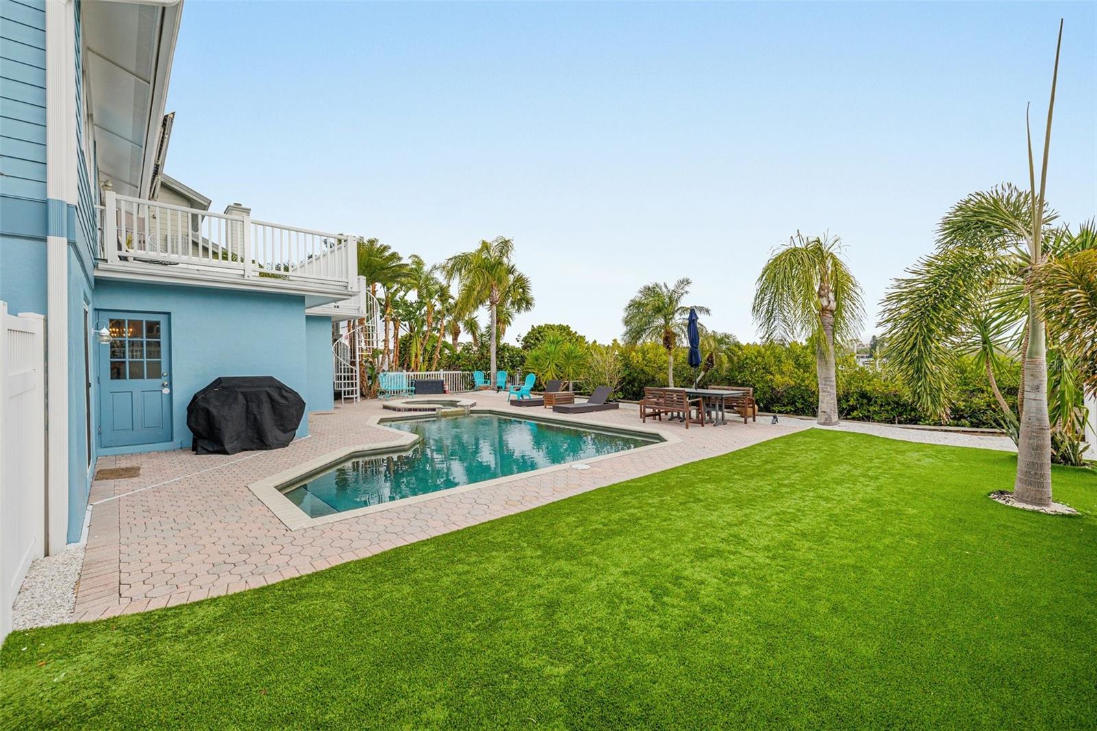 Heated pool with artificial turf.