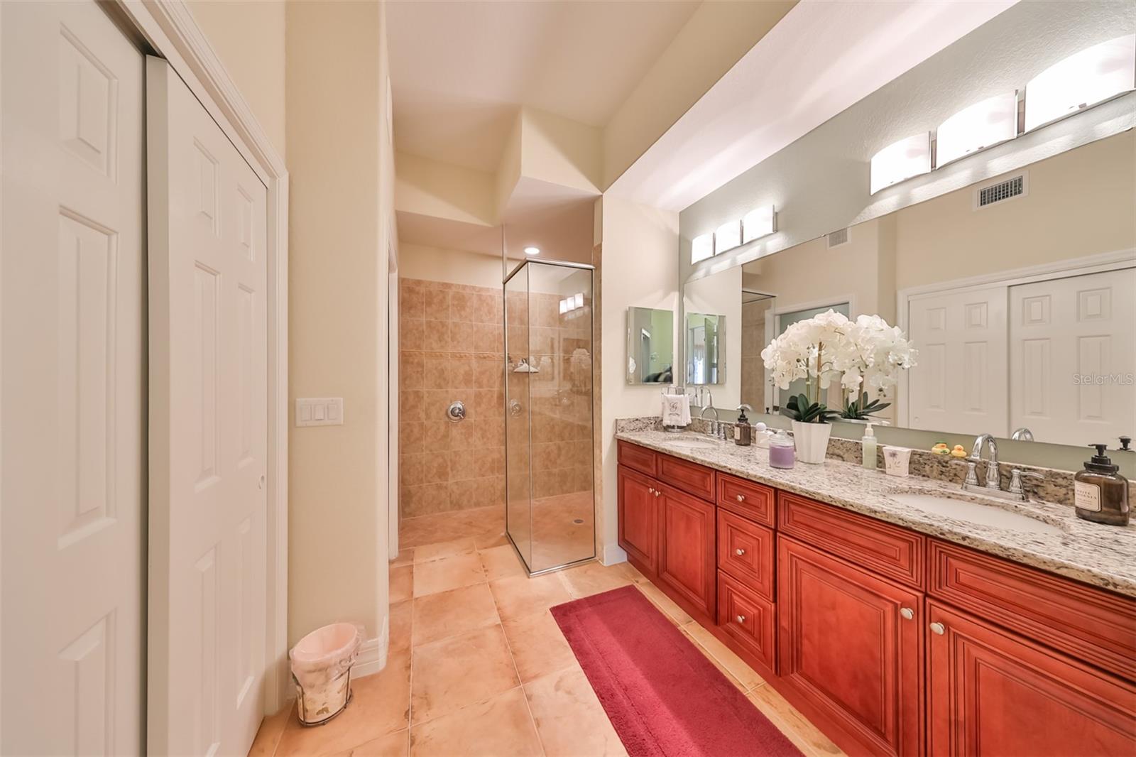 The ensuite bathroom boasts of granite counters, dual sinks, a modern glass shower, a secondary closet, a linen closet and a private water closet.
