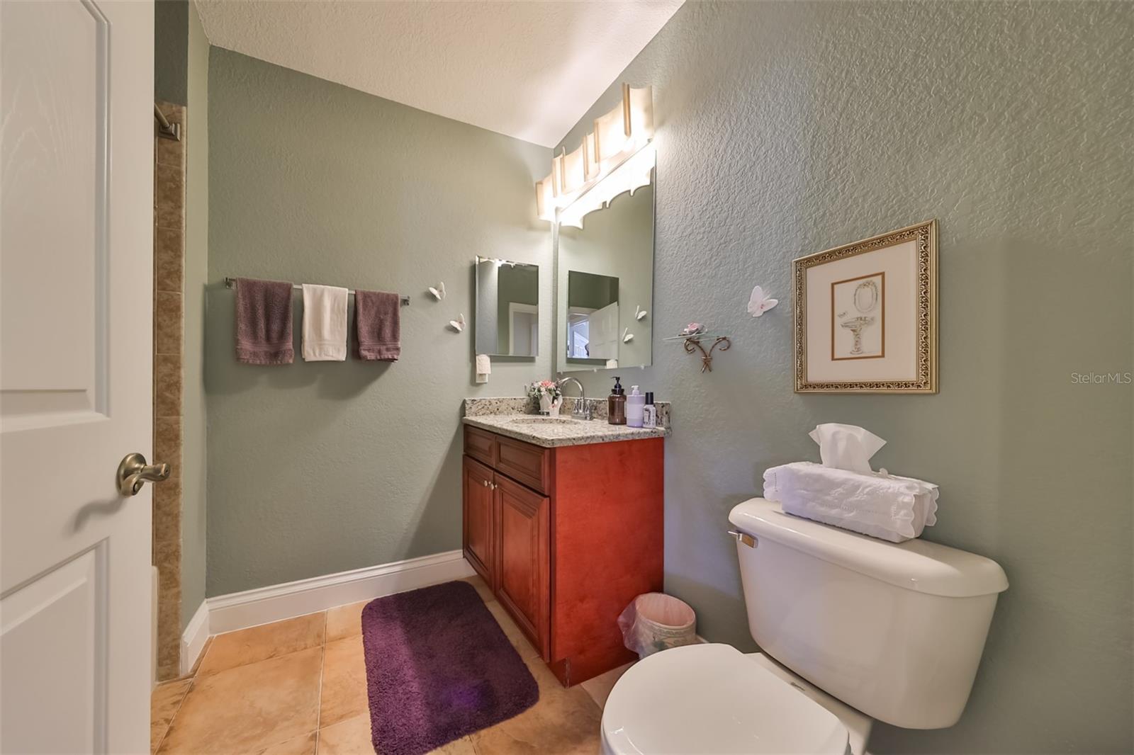 Guest bathroom is sparkling clean with very tasteful contemporary fixtures and neutral paint tones. Notice the custom light fixture for added beauty.