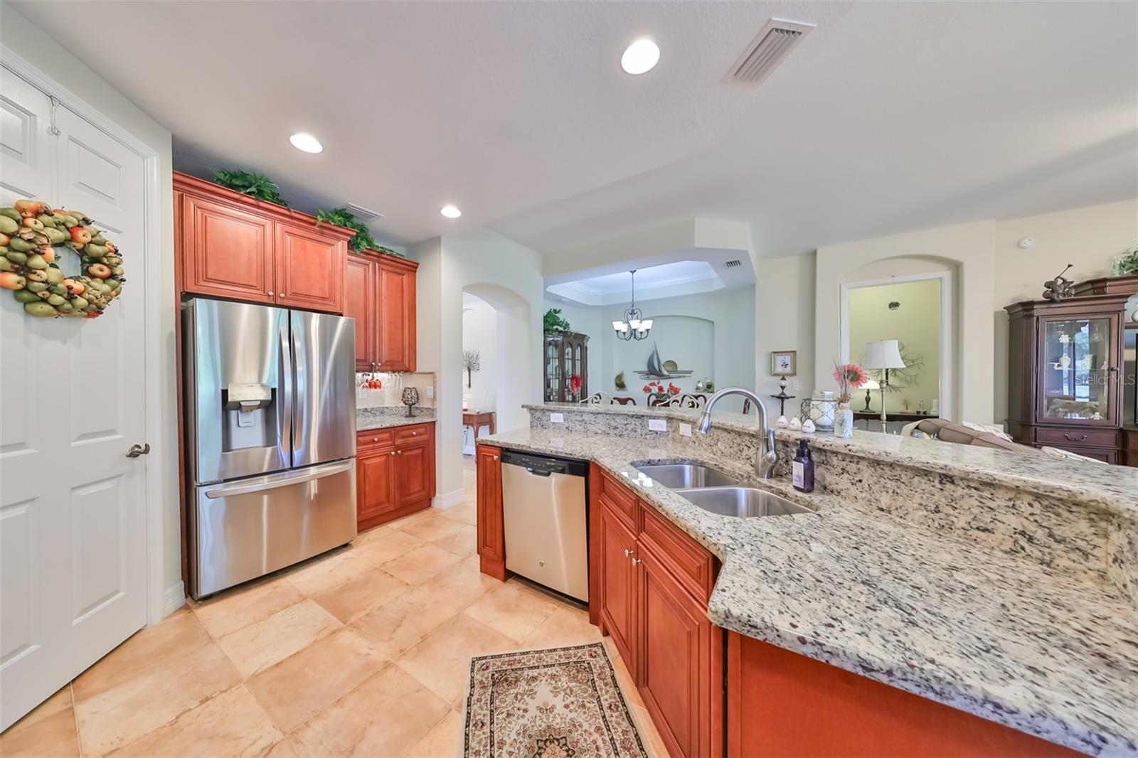 Kitchen has granite counters, under cabinet lighting, newer stainless steel appliances and a walk-in pantry.