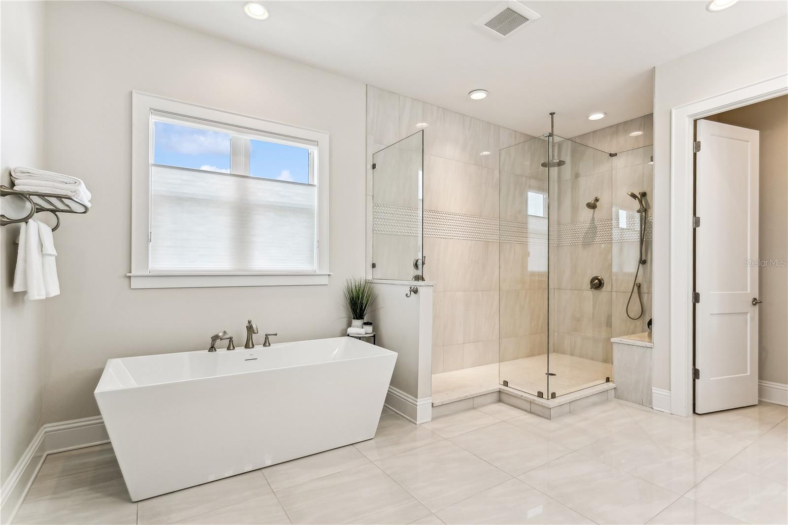 Gorgeous primary bath with shower and soaking tub...