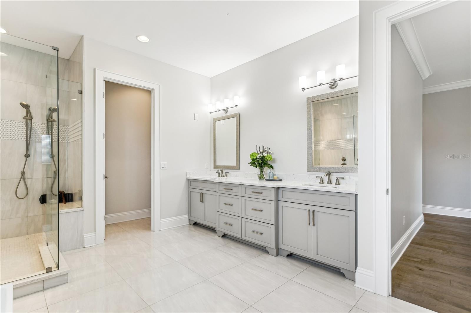 Primary double vanity with separate water closet...