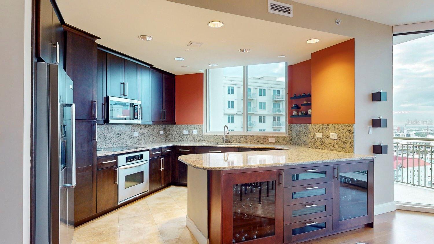 Fully equipped kitchen with ample counter space, including sleek glass-front drawers.
