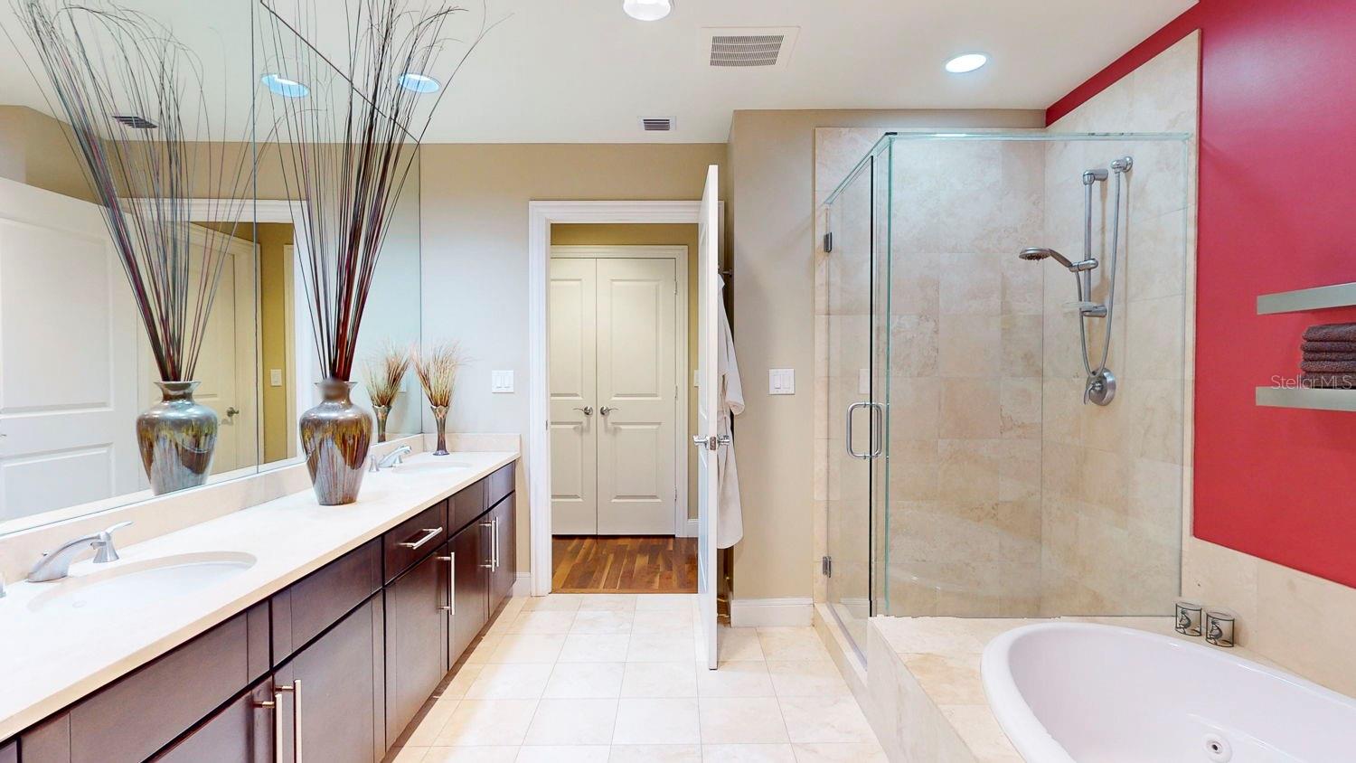 The primary bathroom features both a separate tub and standing shower, providing options for relaxation and rejuvenation.
