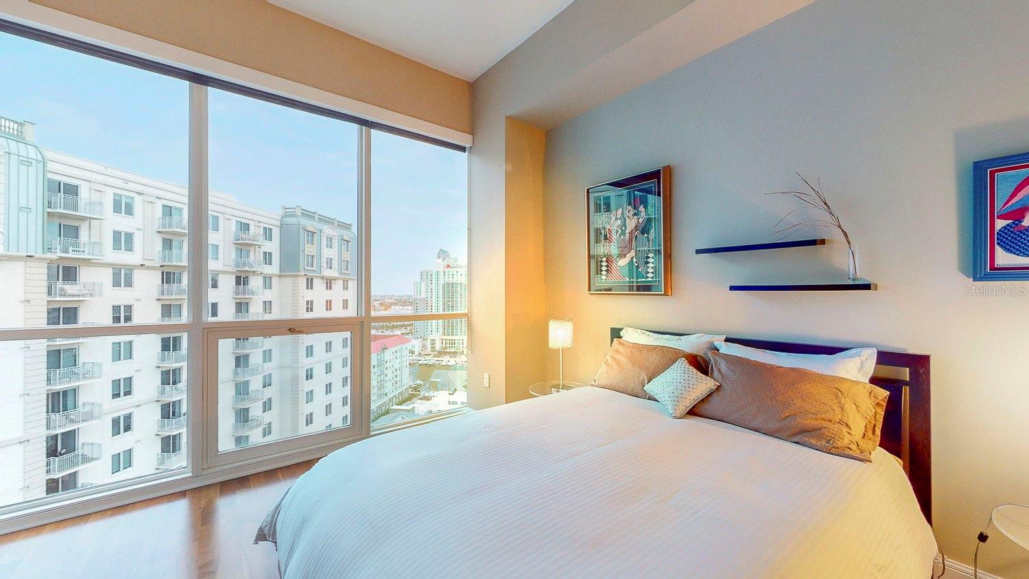 Full floor-to-ceiling windows in each secondary bedroom provide stunning city views.