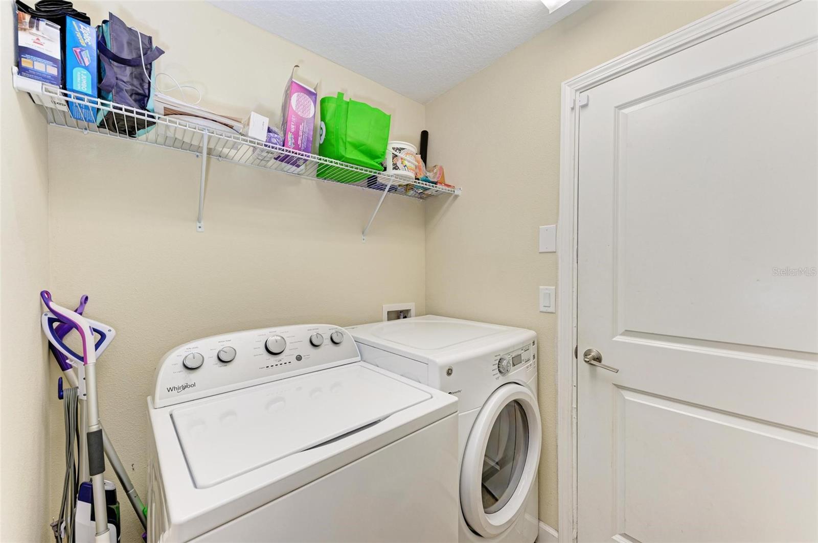 Laundry room with access to garage.  Both stay.