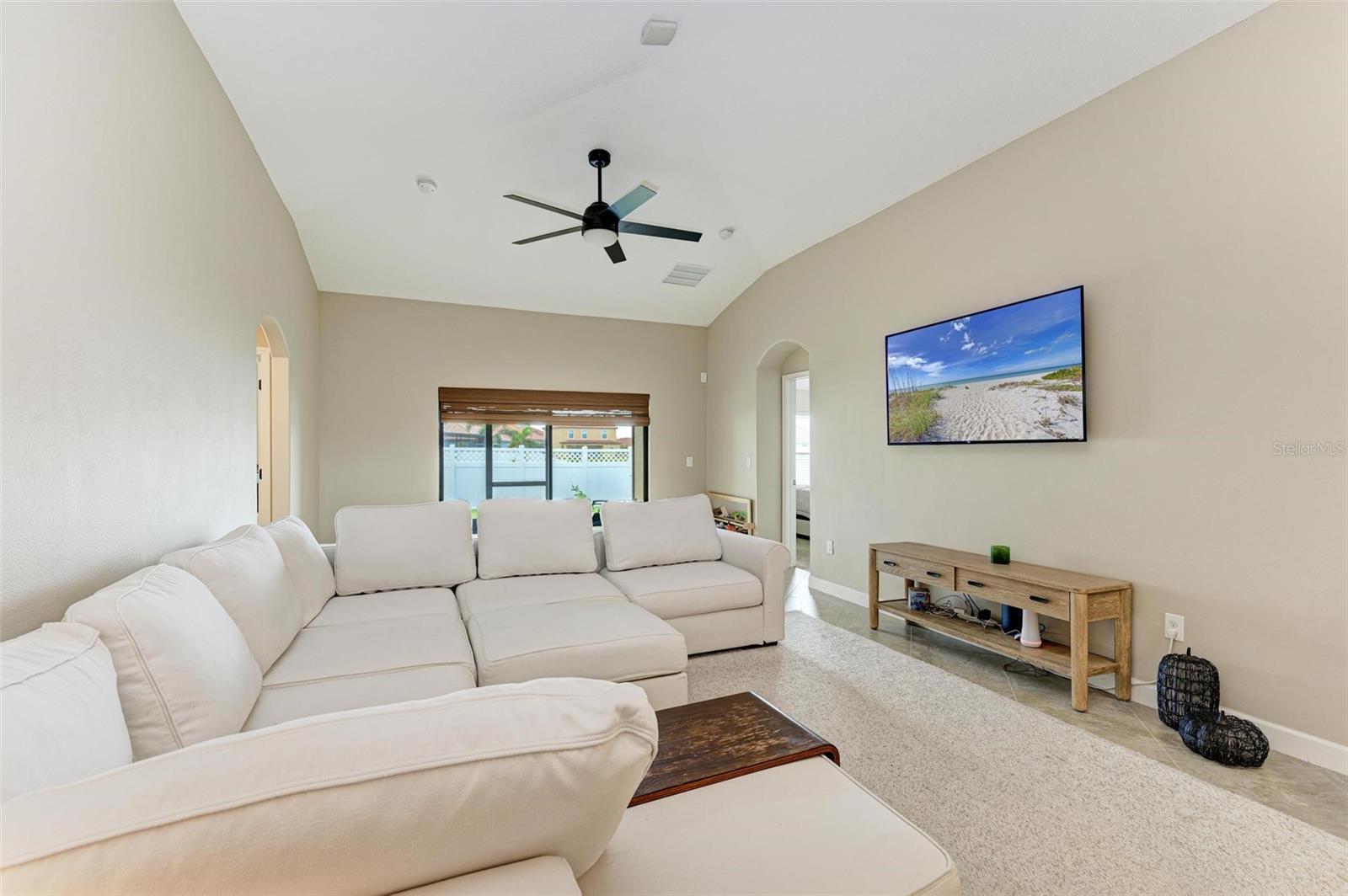 Family room with plenty of room to have the whole family enjoying time together!  Modern ceiling fan and blinds to accentuate the room.