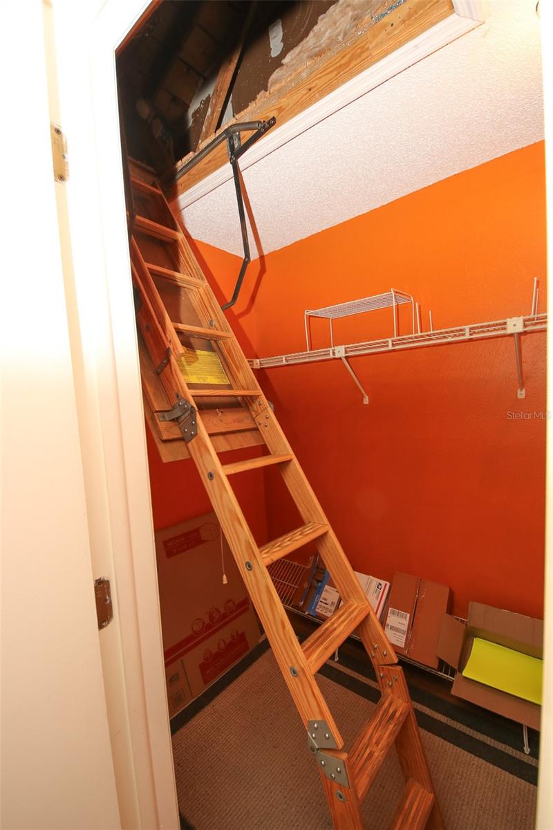 Stairs to attic in primary bedrooom closet