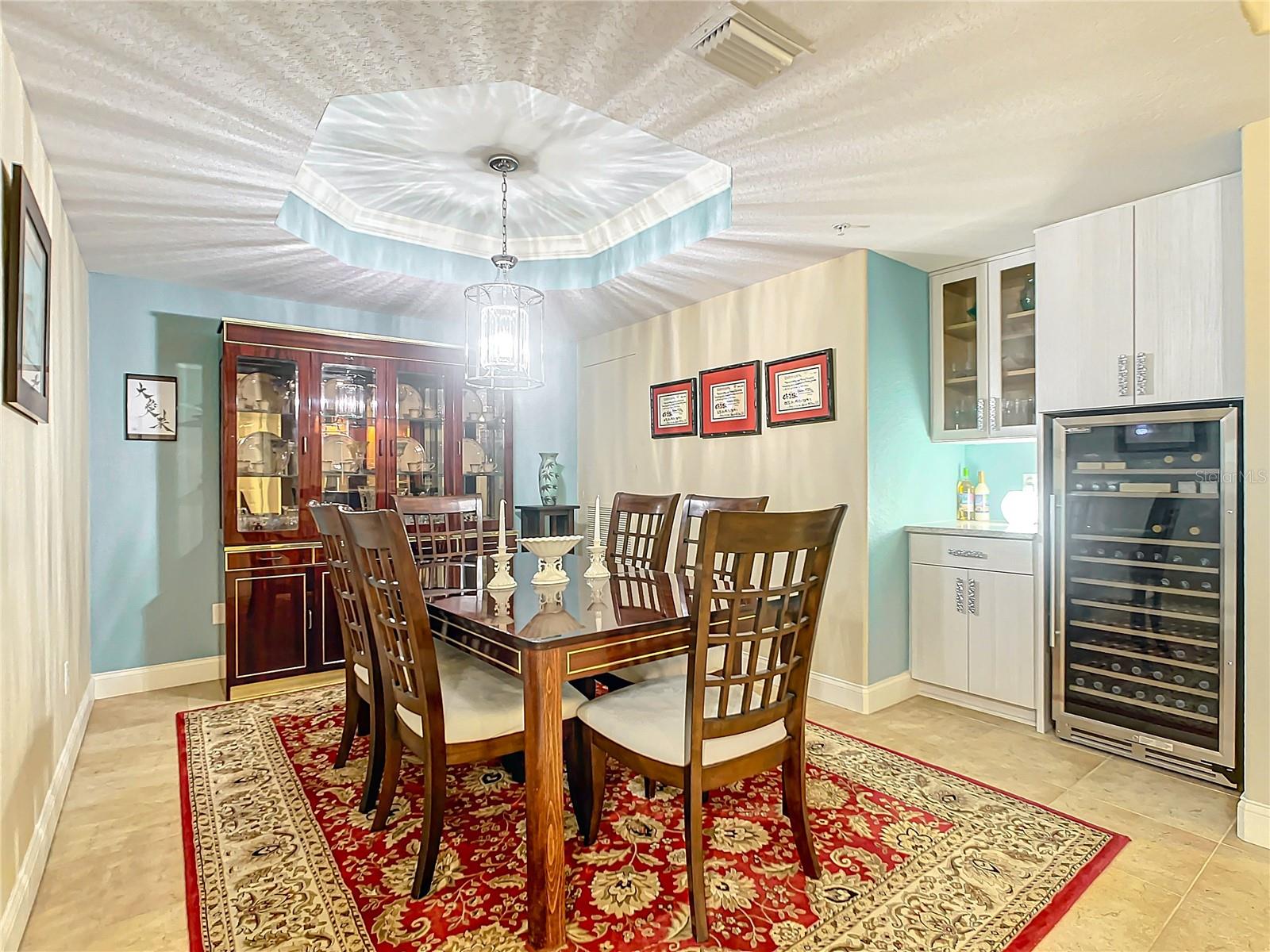 Your dining room is spacious with a 128 bottle wine cooler and dry bar.  Notice the coffered ceiling above