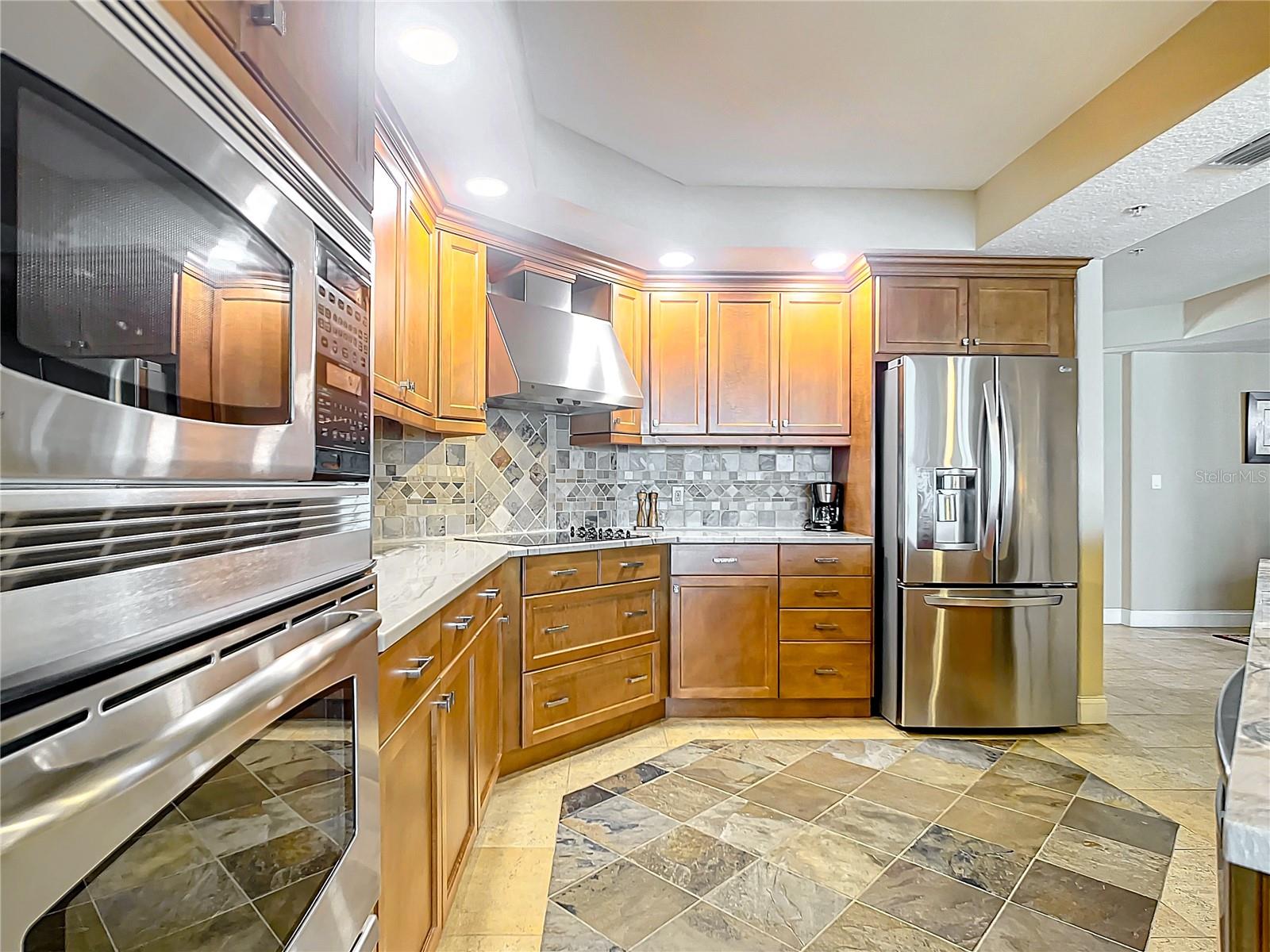 This view shows all the nice stainless steel appliances and how there is enough space for more than one cook