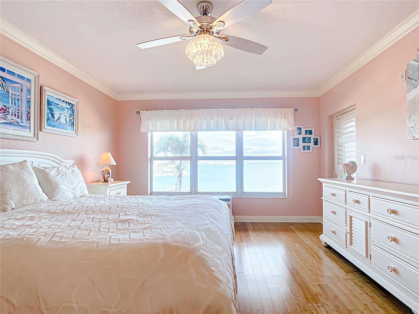 Your primary bedroom has beautiful views looking out to the open water.