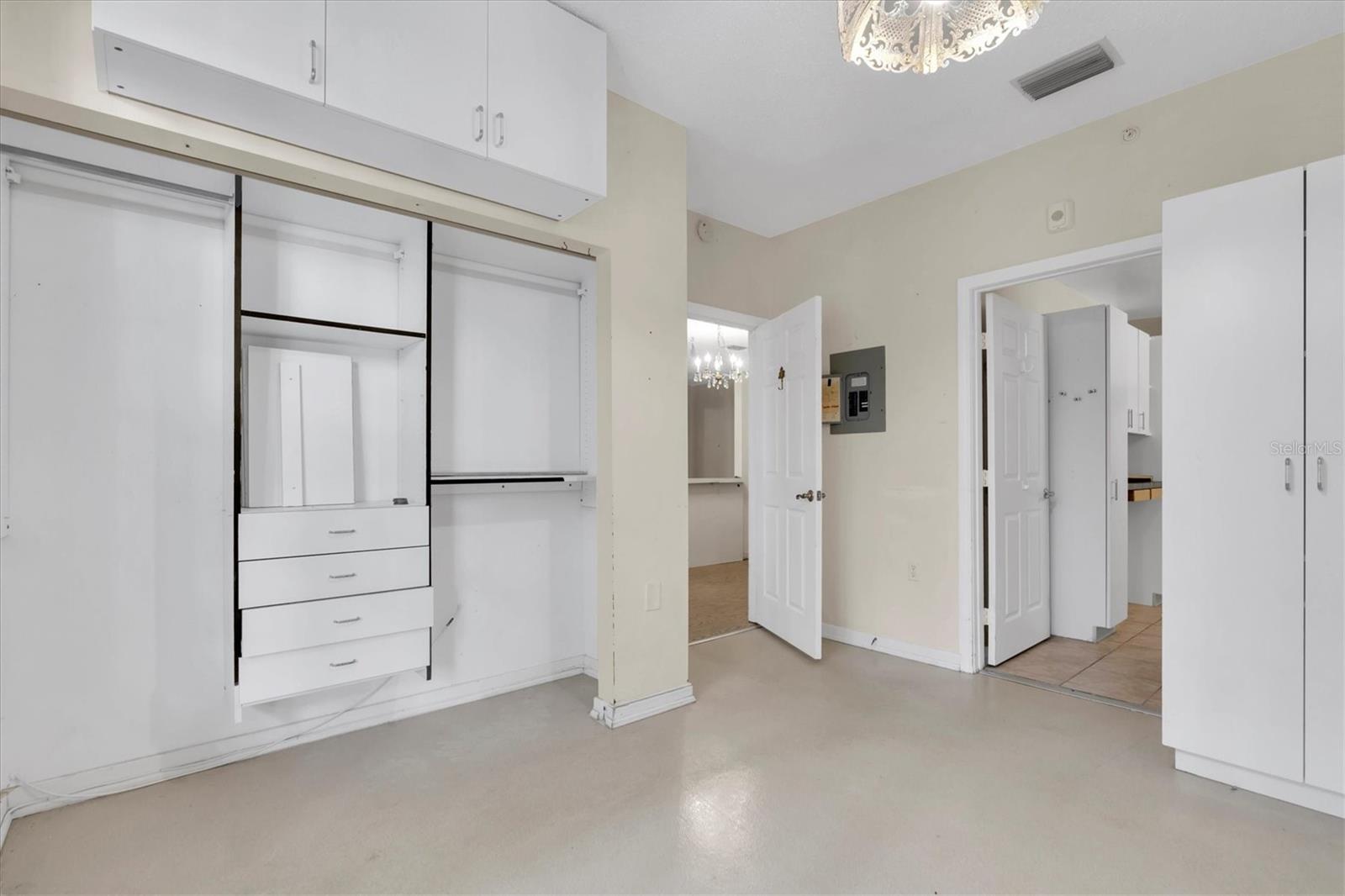 Other Primary bedroom wall backing up to living room. A long closet, some built in shelving. Redesign to works best for you! That is the bathroom entry where you see more closets!