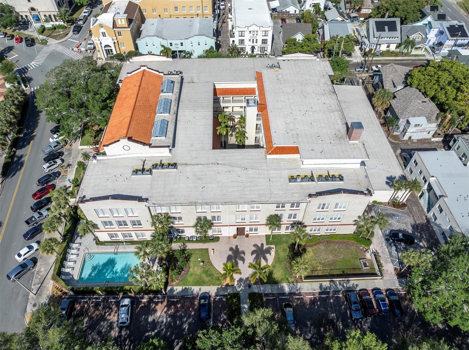 Aerial view! The orange brown portion is the front door. That side of the building looks out to Mirror Lake. Your condo is lower left on the front entry side, down on the ground floor. The brown doorway center ground level is east entry from parking into the building