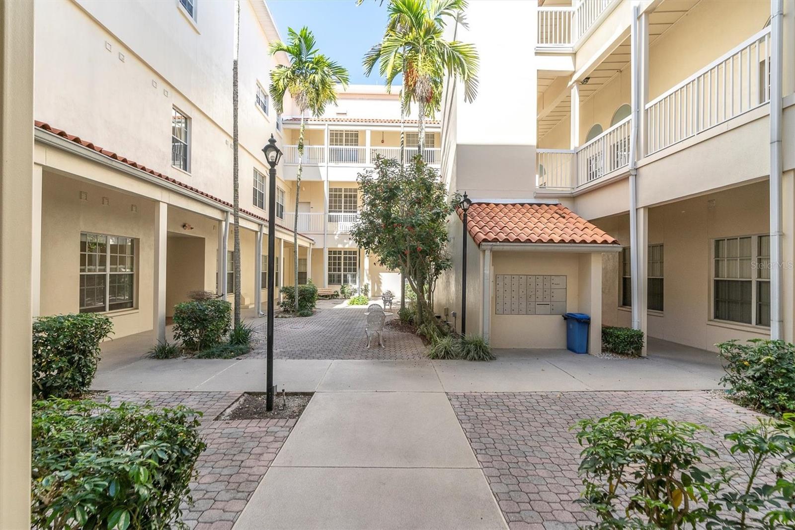 Here's the courtyard, walking in from parking on the east side. Those ground floor windows on your left are the unit. Ahead are the mailboxes, so deliveries are safe from outside interference