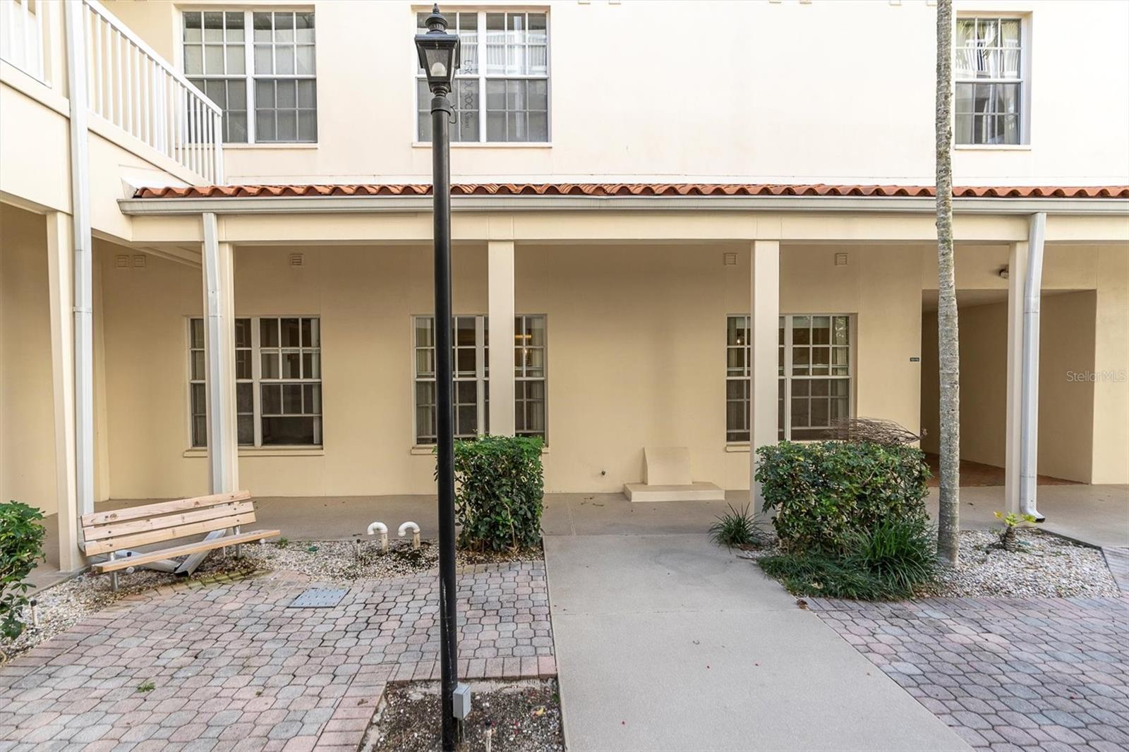 Full view of unit from courtyard. Three sets of windows looking out
