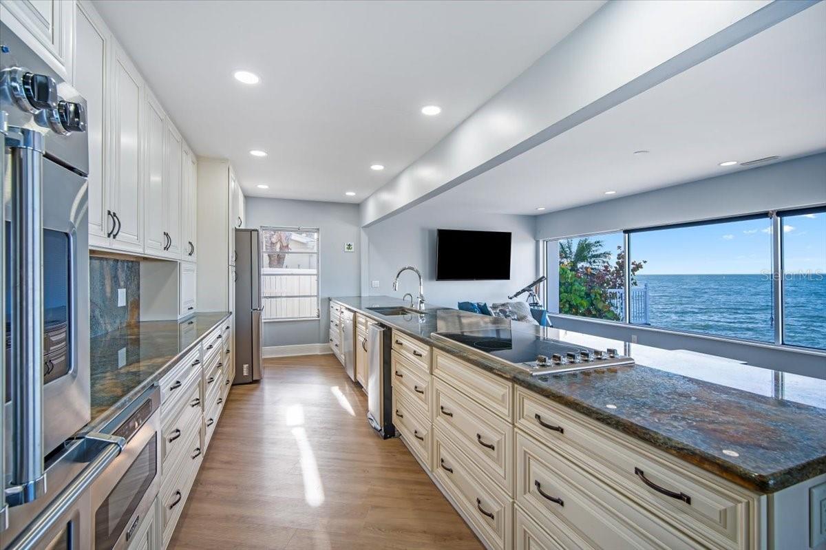 Picture yourself cooking in this stunning kitchen with a cooktop, stainless steel appliances and a view of the water