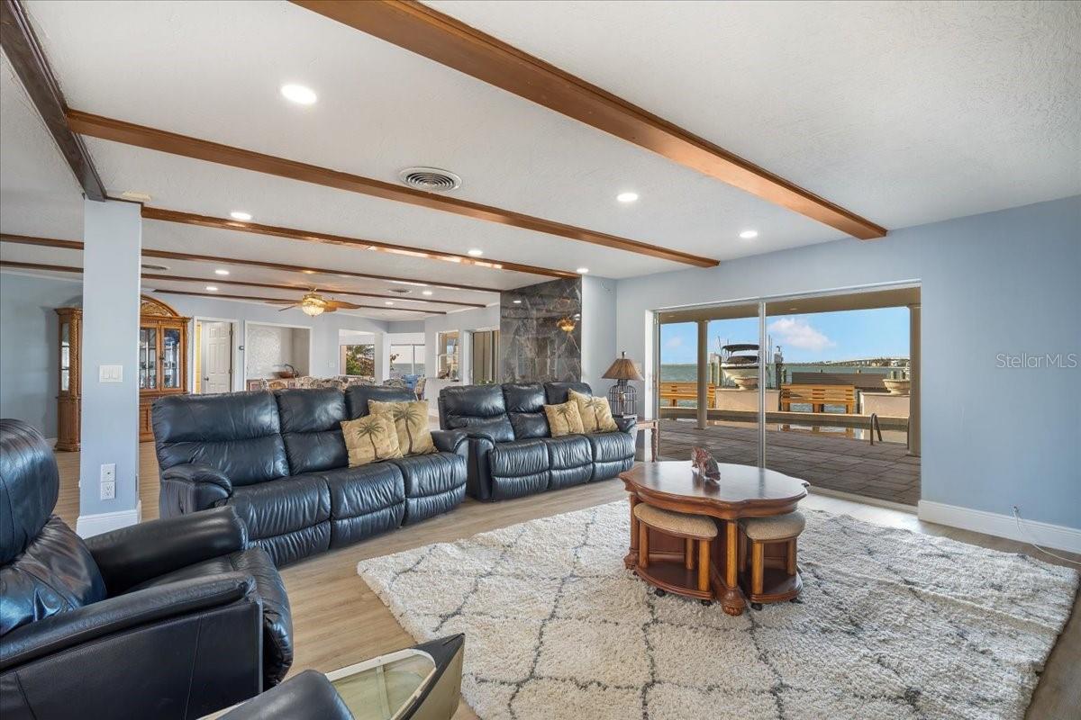 Upon entering the house, you step into a spacious open family area with stunning views, sliding doors that allow for seamless enjoyment of the outdoor breeze.